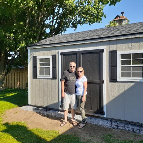 Cottage storage shed with shutters